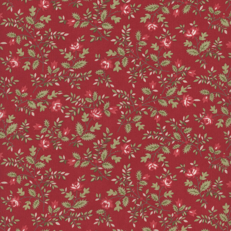 Red fabric with swirling leafy green vines and red blooms.