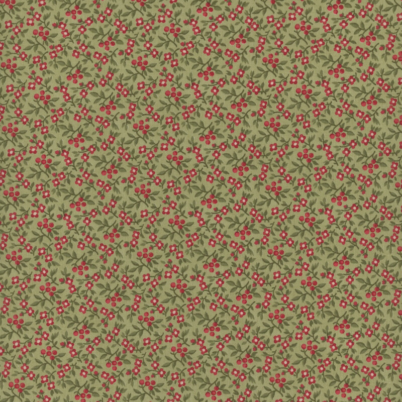 This fabric features small red flowers and green leaves crowded on a green background