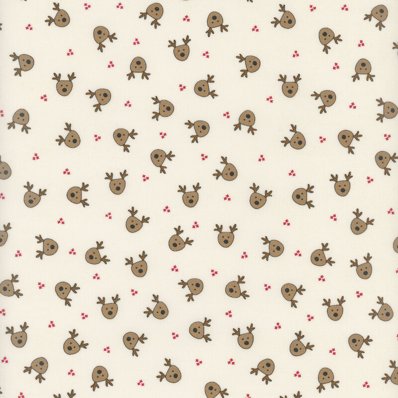 This cream fabric features small brown illustrated reindeer heads evenly spaced and tossed all over.