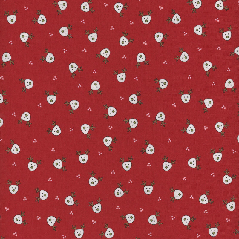 This red fabric features small white illustrated reindeer heads evenly spaced and tossed all over.