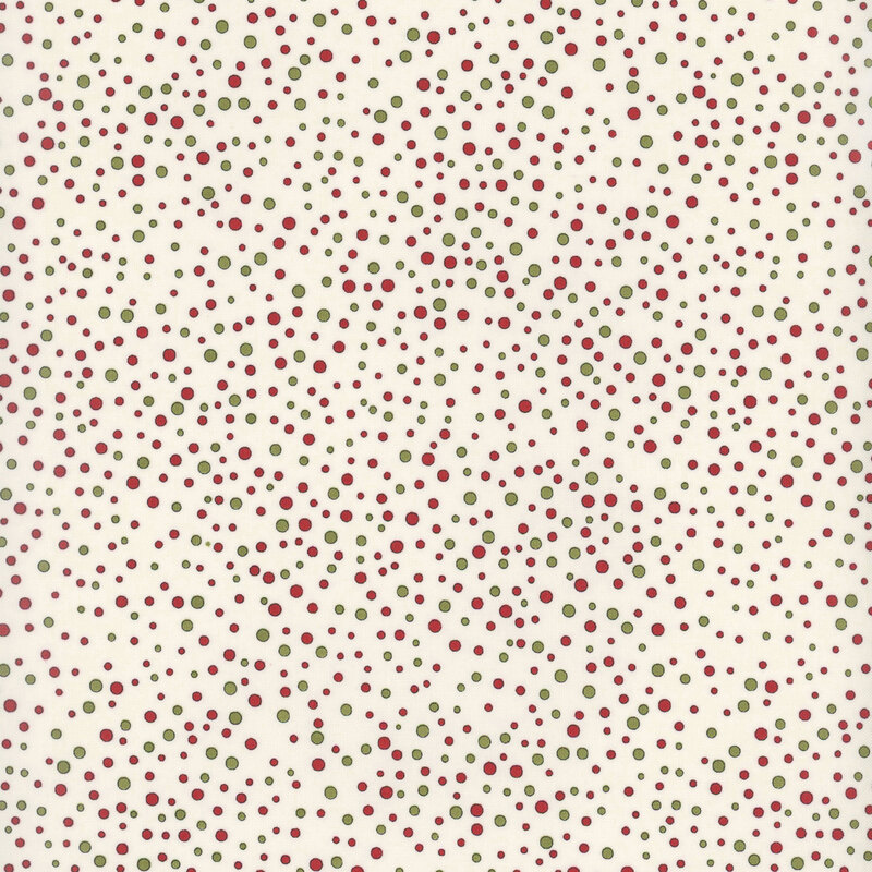 Red and green dots ranging in size and scattered across cream fabric.