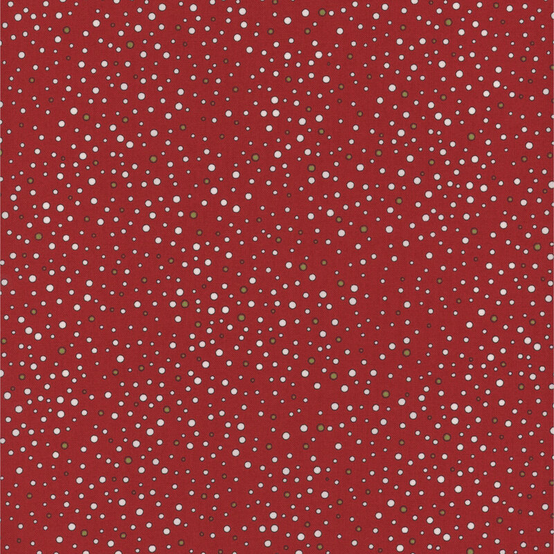 White and green dots ranging in size and scattered across red fabric.