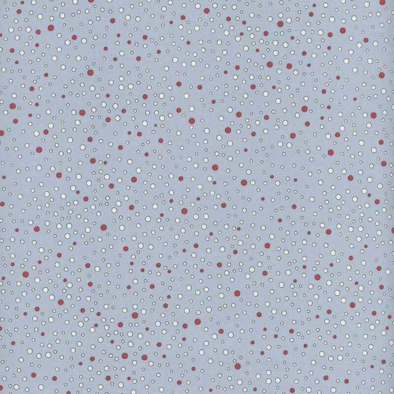 Red and white dots ranging in size and scattered across light blue fabric.