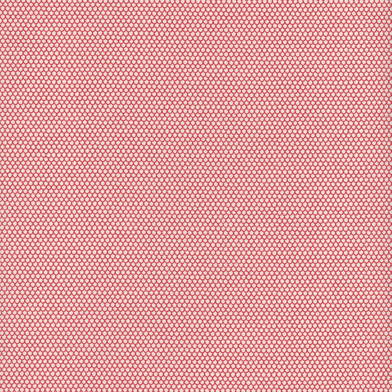 This fabric features rows and rows of tiny red scalloped shapes on a white background