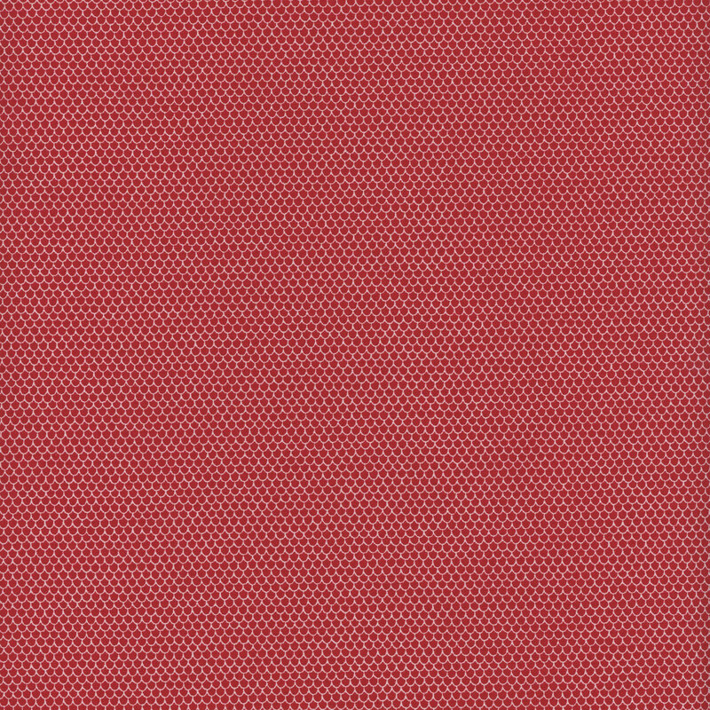 This fabric features rows and rows of tiny white scalloped shapes on a red background