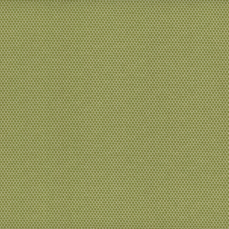 This fabric features rows and rows of tiny white scalloped shapes on a green background