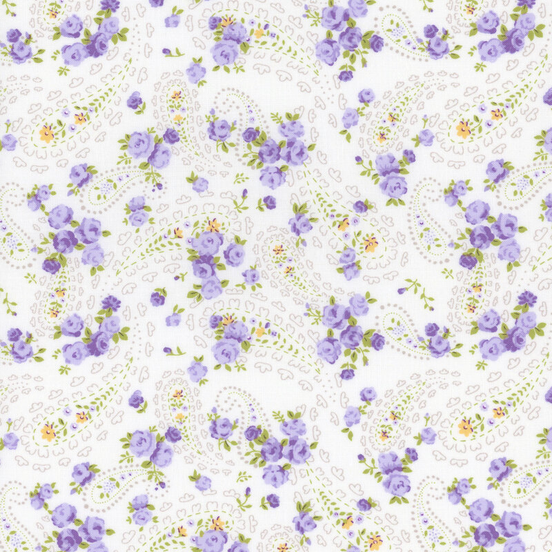 off white fabric with scattered intricate paisley motifs, amidst small purple and yellow florals