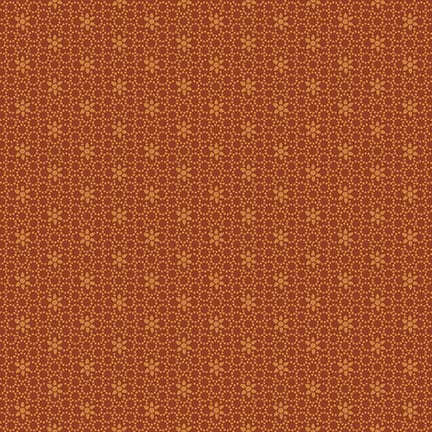 burnt orange fabric featuring a packed circular design and a floral pattern