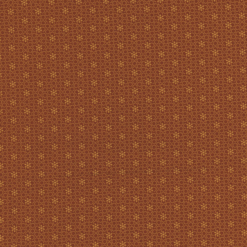 burnt orange fabric featuring a packed circular design and a floral pattern