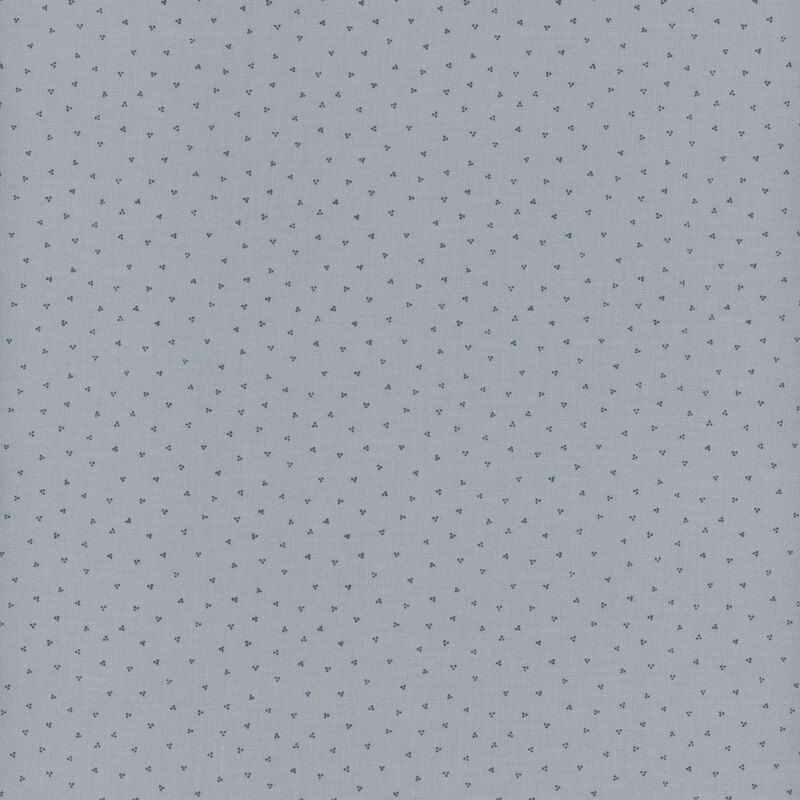 dusty blue fabric with scattered navy blue clusters of dots