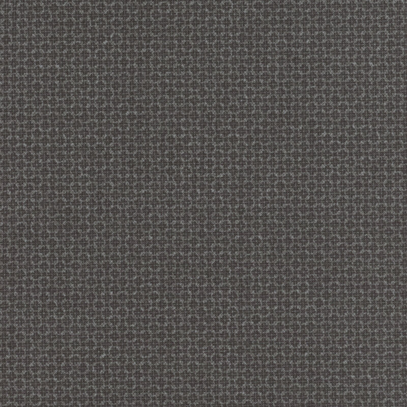 dark gray flannel fabric featuring packed together tonal squares and crosses