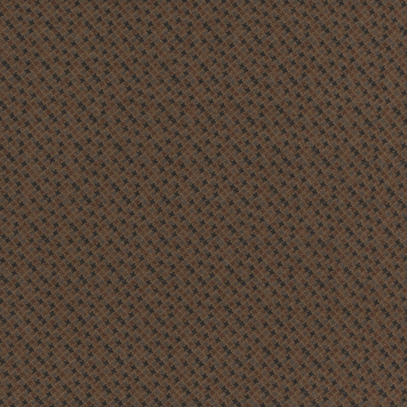 brown flannel fabric featuring packed together brown, gray, and black 4-pointed stars
