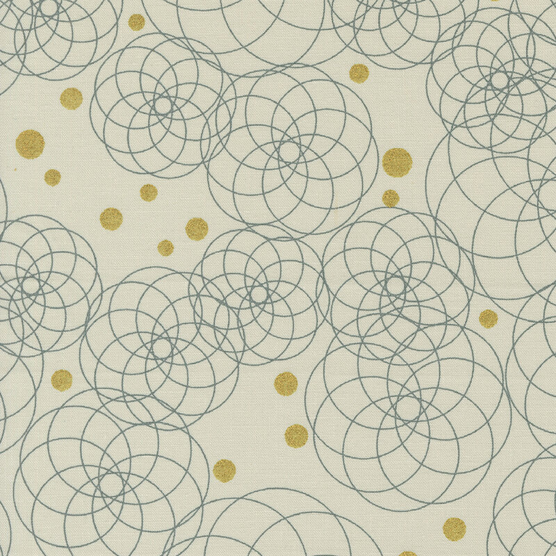 This fabric features beautiful circular fractal patterns interspersed among gold metallic dots on an ecru background
