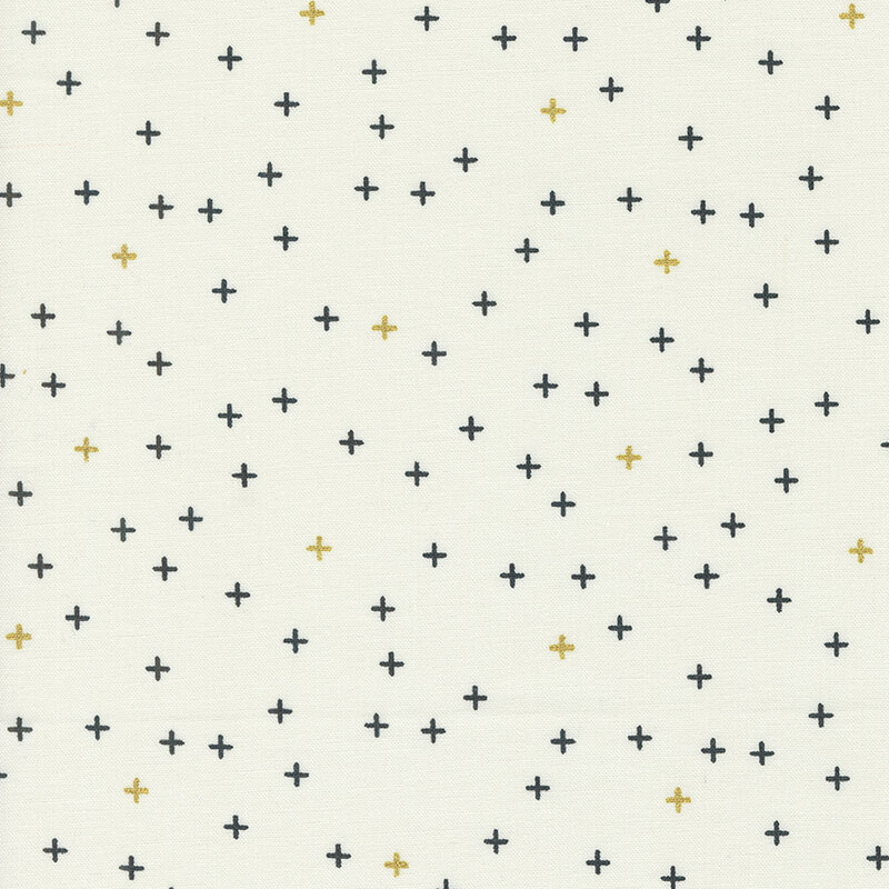 Simple cream fabric featuring tiny black and gold metallic crosses all over.