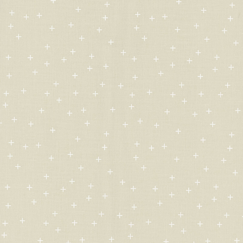 Simple ecru fabric featuring tiny white crosses all over.