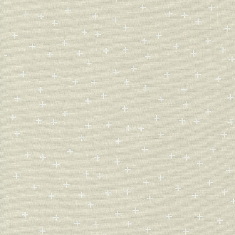 Simple ecru fabric featuring tiny white crosses all over.