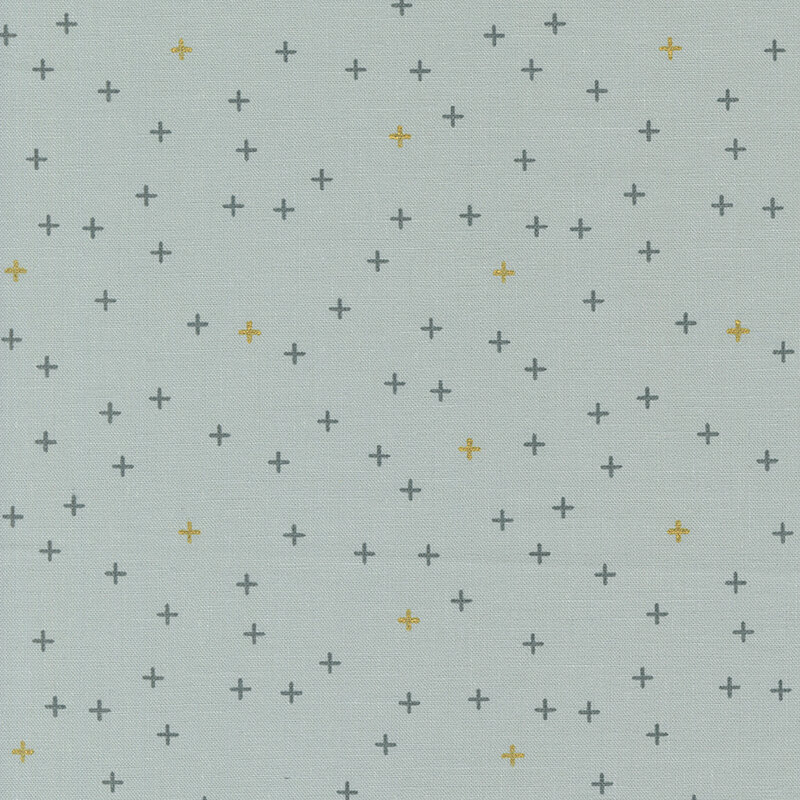 Simple light gray fabric featuring tiny gray and gold metallic crosses all over.