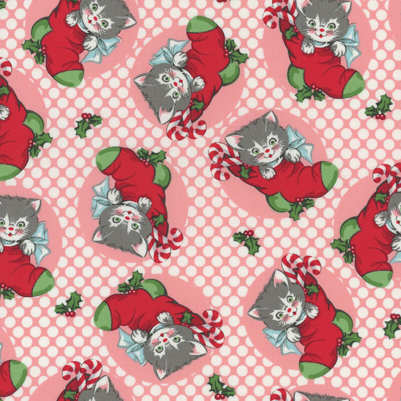 pink fabric featuring white polka dots and scattered white and gray kittens in red and green stockings