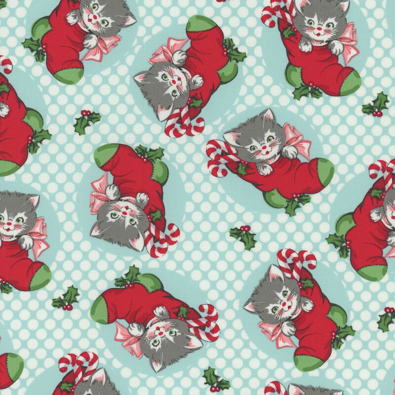 icy blue fabric featuring white polka dots and scattered white and gray kittens in red and green stockings
