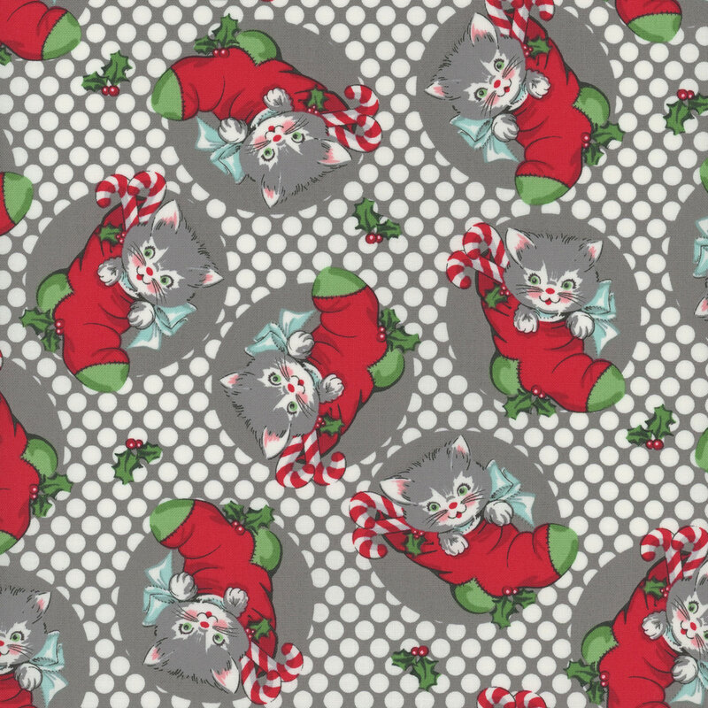 gray fabric featuring white polka dots and scattered white and gray kittens in red and green stockings
