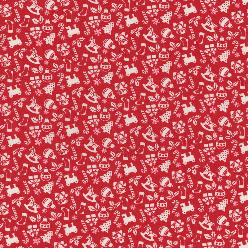 candy red fabric featuring scattered white Christmas motifs, including holly, bells, rocking horses, snowflakes, presents, Christmas trees, candy canes, stockings, trains, and ornaments