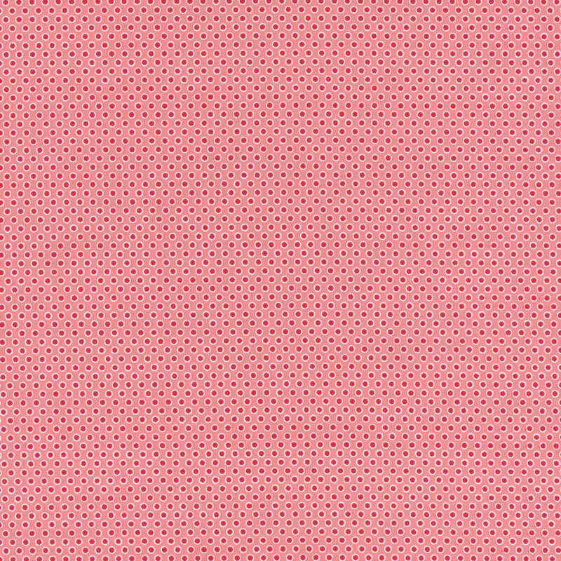 pink fabric featuring candy red polka dots with an off white outline