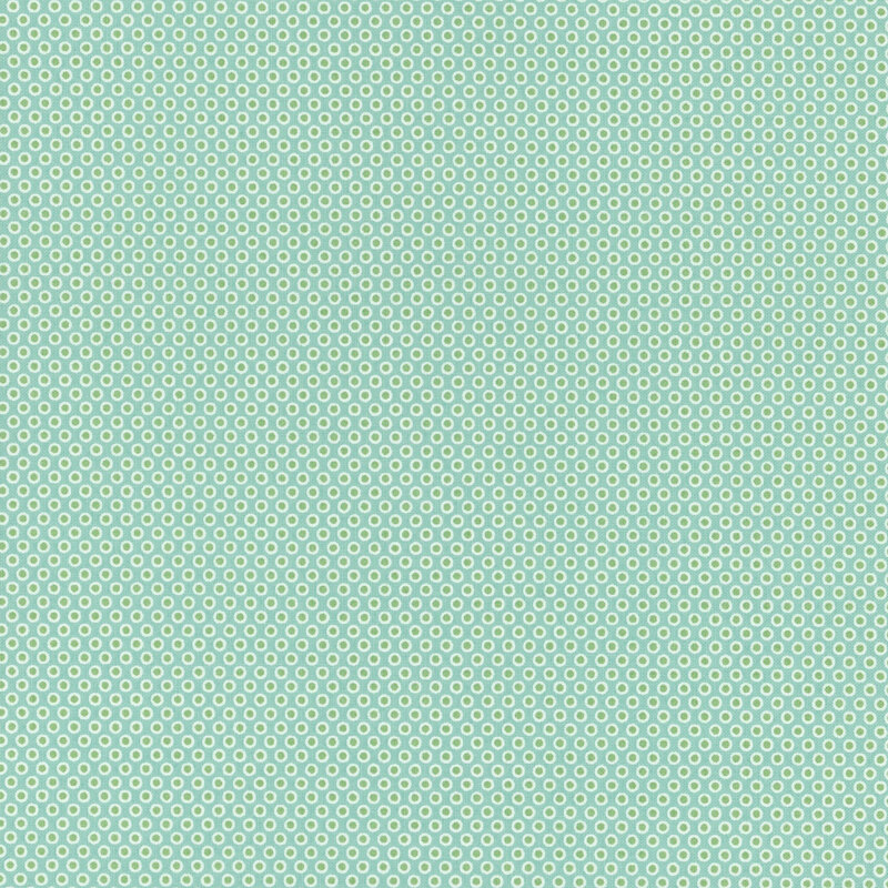 icy blue fabric featuring leaf green polka dots with an off white outline