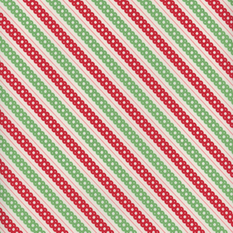off white fabric featuring candy red and leaf green diagonal scalloped lace stripes and thin pink striping accents