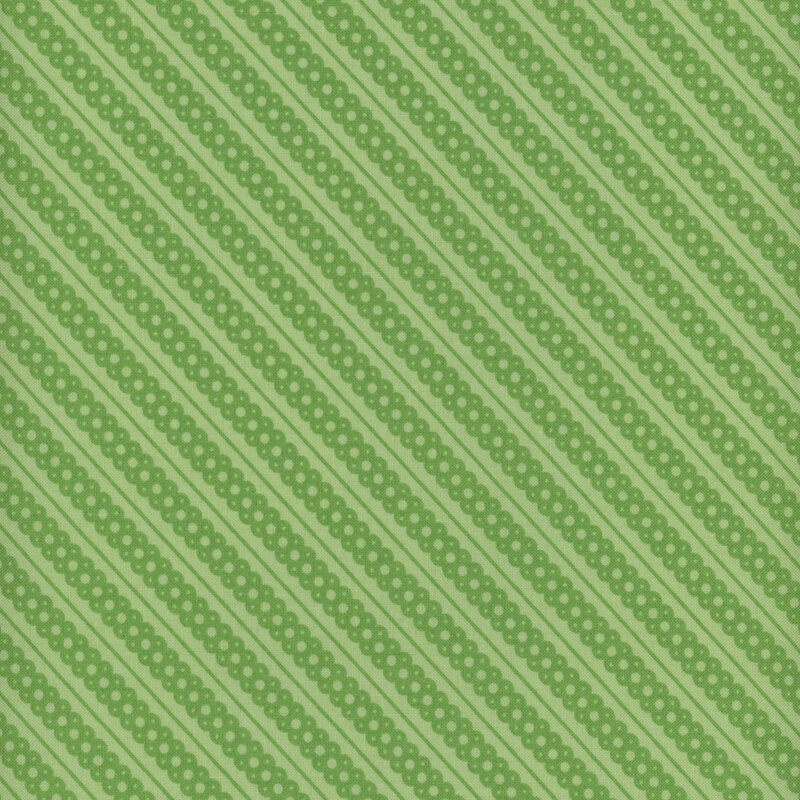 soft green fabric featuring leaf green diagonal scalloped lace stripes and thin striping accents