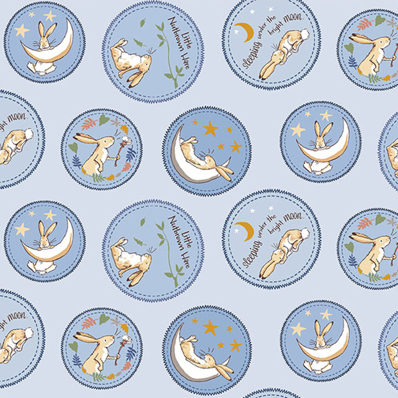 Denim blue fabric featuring tonal circular medallions, each featuring a small scene and phrases from the book with Little Nutbrown Hare.