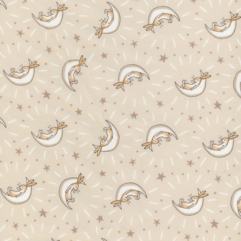 Khaki fabric featuring stars and bunnies cradled in cream crescent moons.