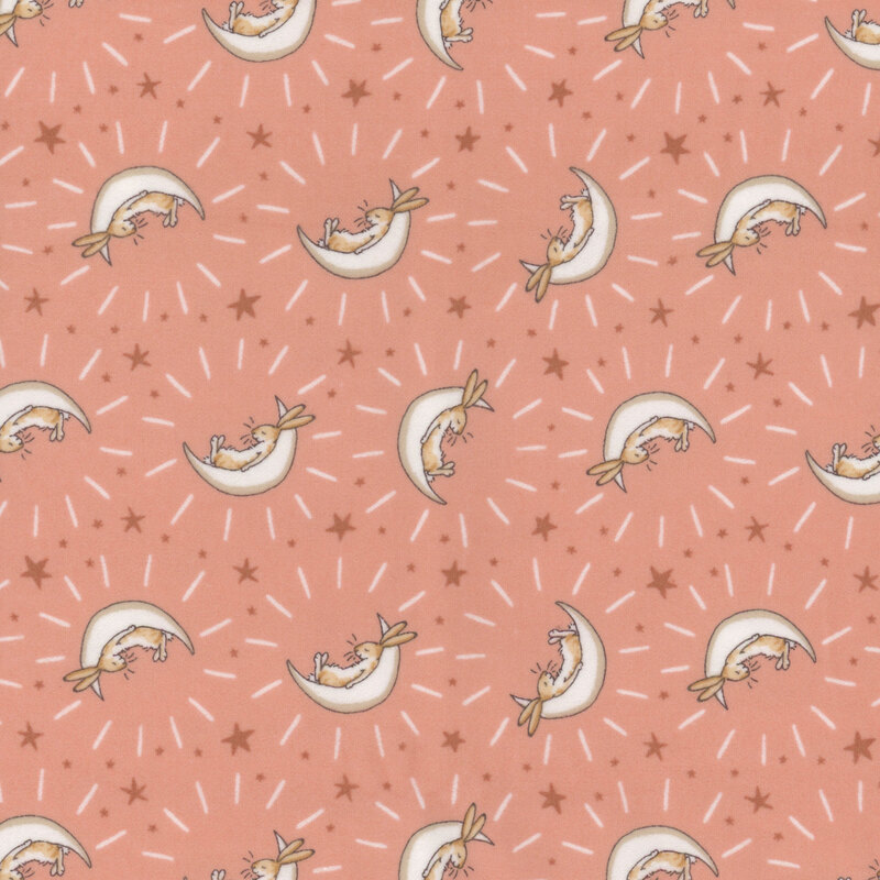 Coral fabric featuring stars and bunnies cradled in cream crescent moons.