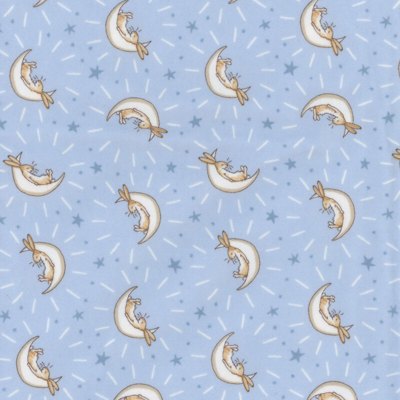 Blue fabric featuring stars and bunnies cradled in cream crescent moons.