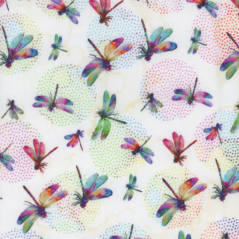 White fabric with large round shapes made up of multicolored dots in the background of multicolored dragonflies in various sizes tossed all over.