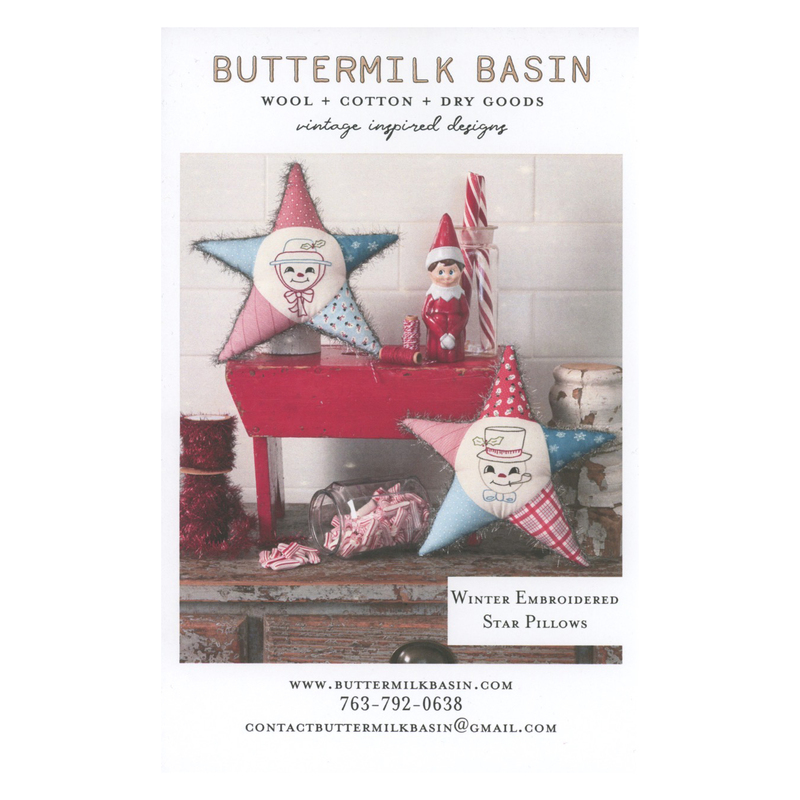 Front cover of pattern showing the two finished projects staged on a rustic wood table decorated with festive twine and candy canes.