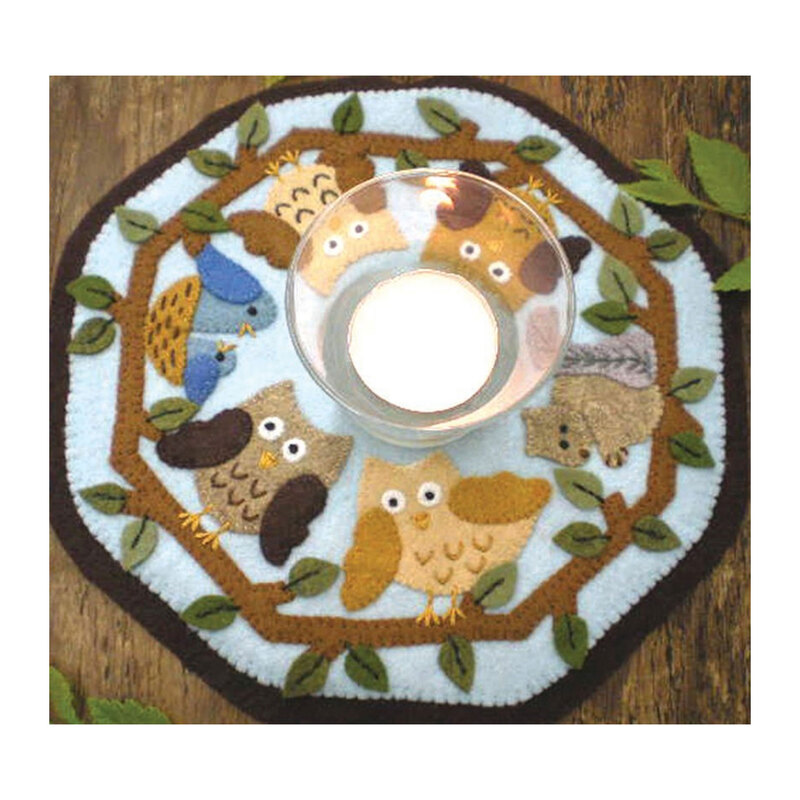 photo of candle mat featuring owls, squirrels, and birds on tree branches