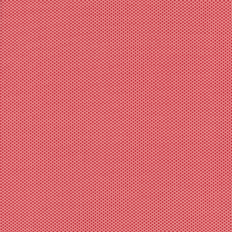 vivid pink fabric featuring a dotted halftone red print