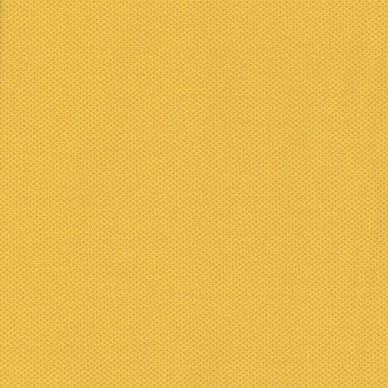 muted golden yellow fabric featuring a dotted halftone tonal print