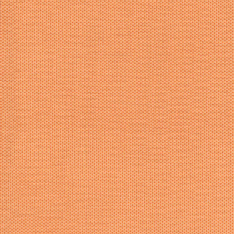 light orange fabric featuring a dotted halftone tonal print