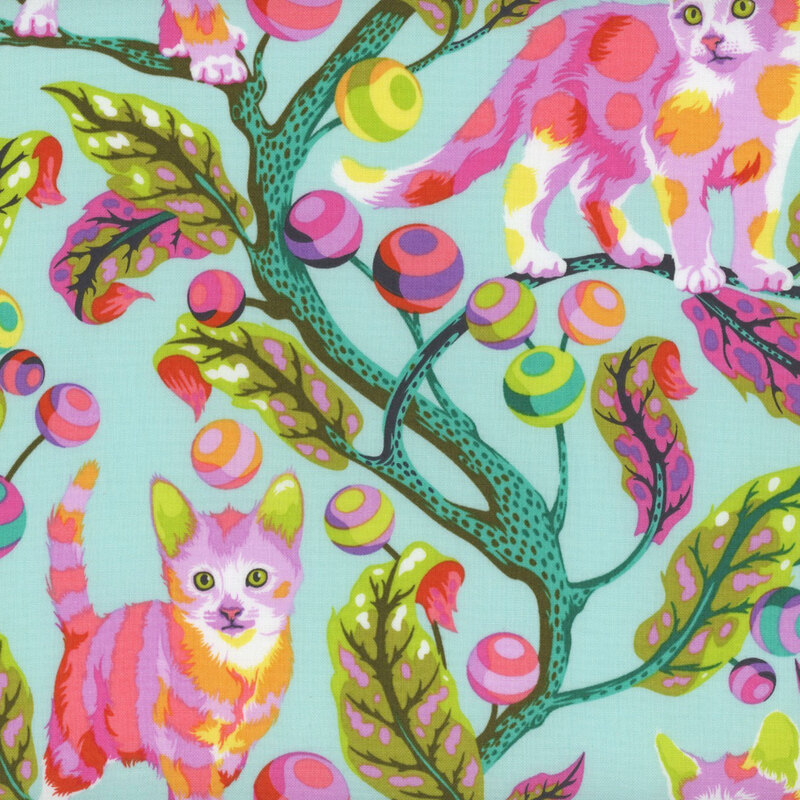 bright aqua fabric featuring teal branches growing striped ball toys and colorful spotted cats scattered throughout the leaves