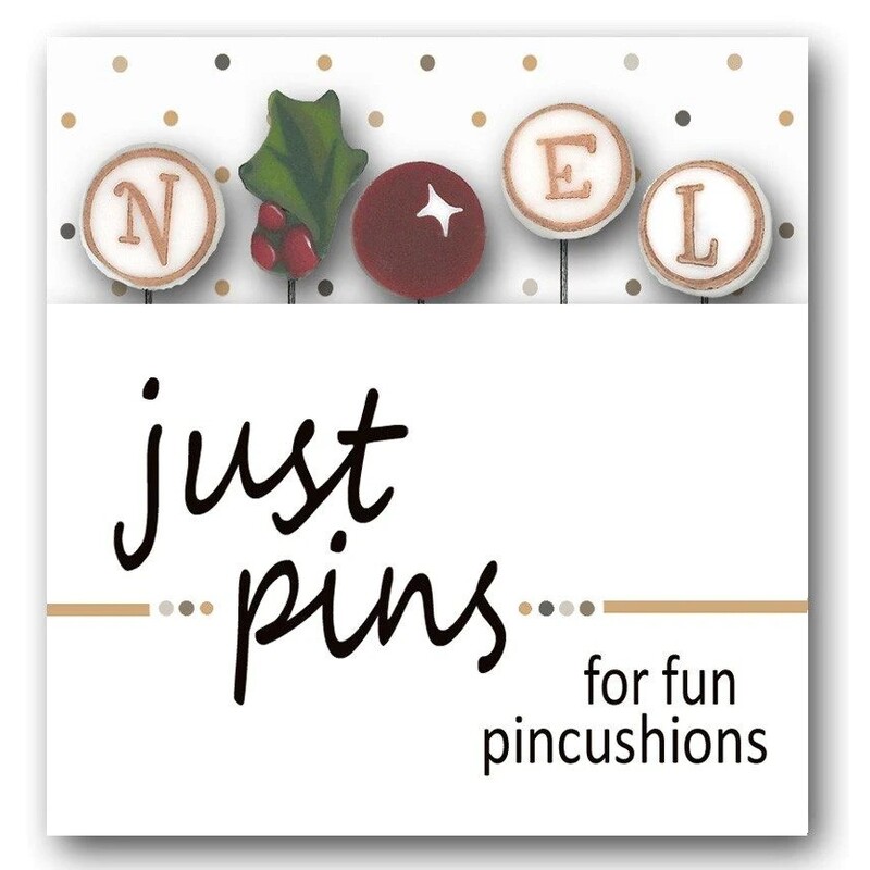 A digital mockup of the packaging for the pins, showing a holly bough, the letters N, E, and L, and a red holly berry to serve as the O in 