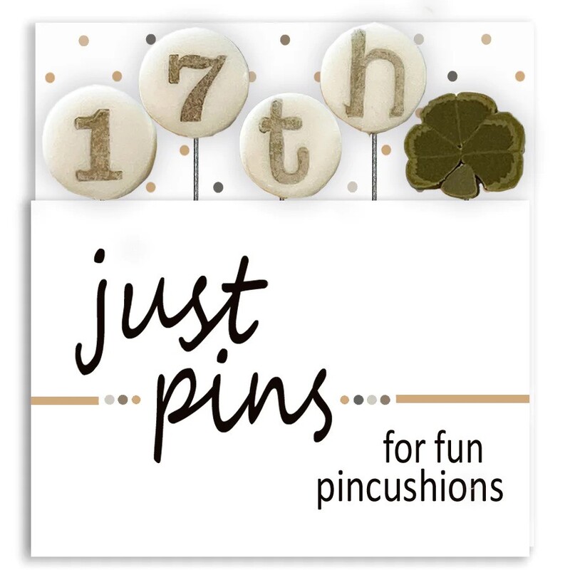 A digital mockup of the packaging for the pins, showing a clover and the letters and numbers to spell out 