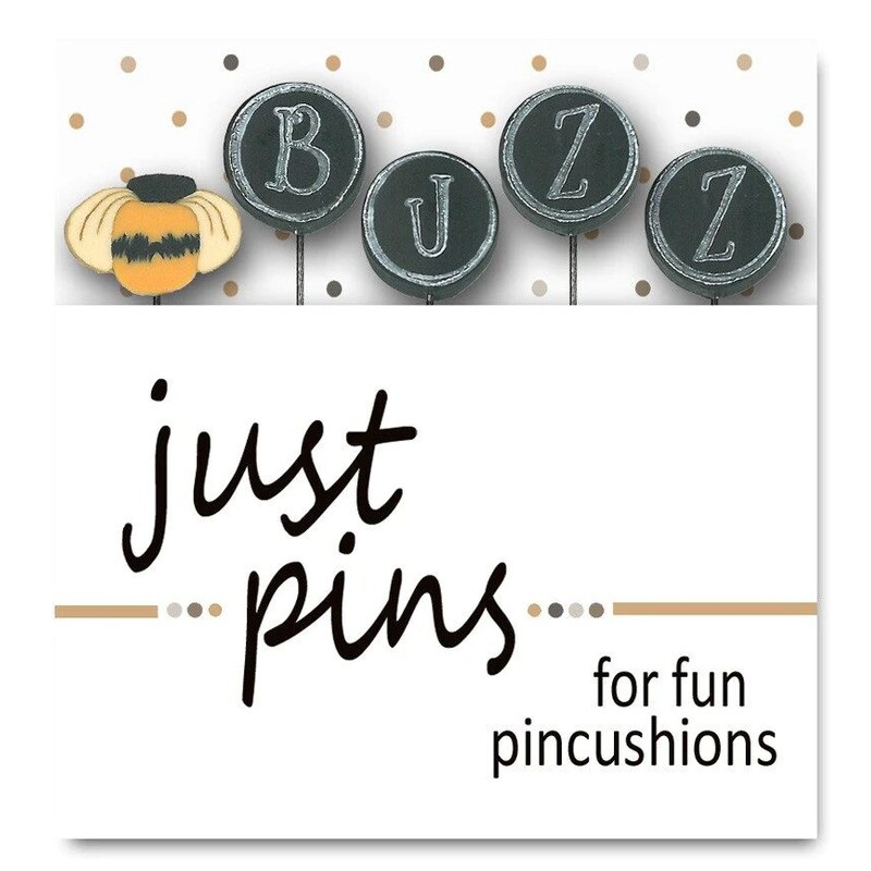 A digital mockup of the packaging edited with the real pins, showing a little bumblebee and the letters to spell out 