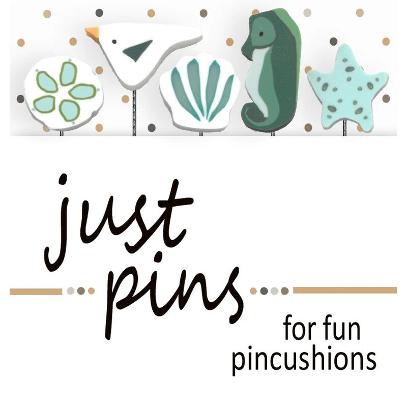 A digital mockup of the packaging edited with the real pins, showing two seashells, a starfish, a seagull, and a seahorse.