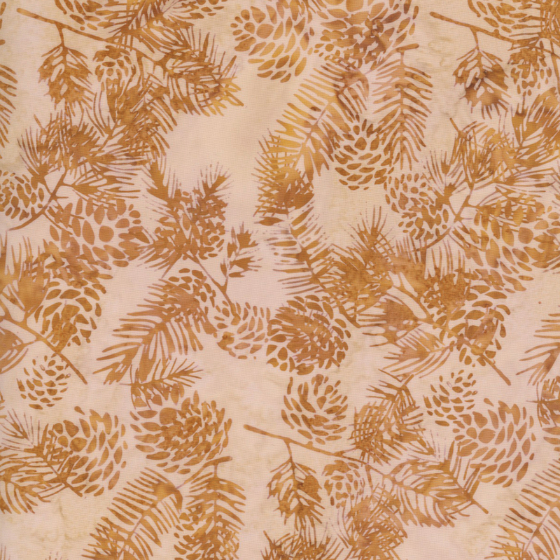 lovely cream mottled batik fabric featuring scattered golden brown and tan mottled pine cones and fir needle branches