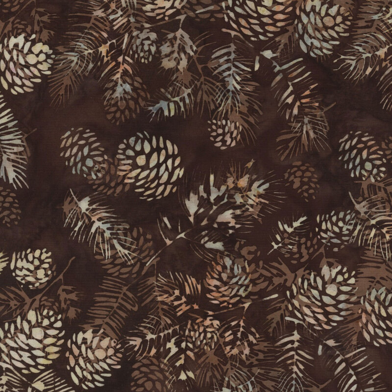 lovely dark brown mottled batik fabric featuring scattered tan and cream mottled pine cones and fir needle branches