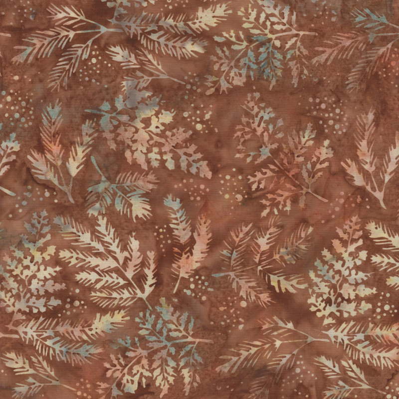 gorgeous brown mottled batik fabric featuring scattered tan, orange, green, and cream mottled leaf and pine needle sprigs