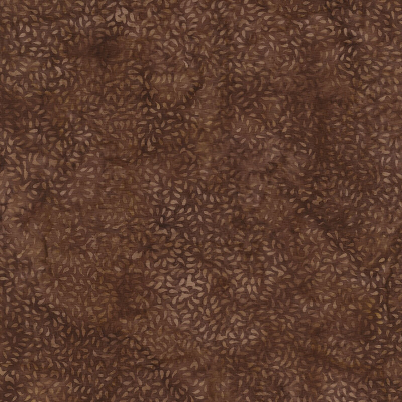 beautiful brown mottled batik fabric featuring small packed together tan mottled leaves