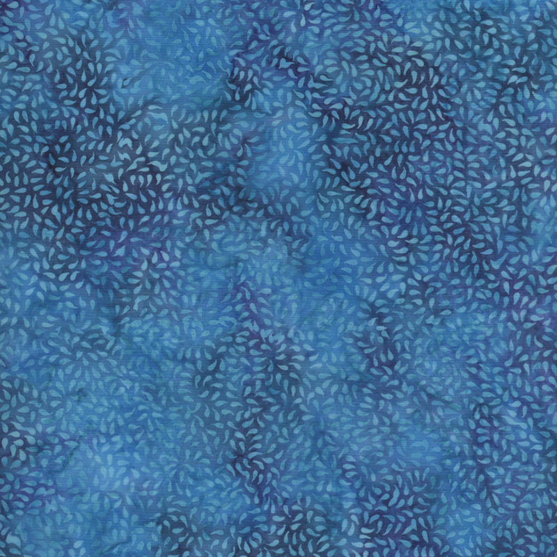 beautiful blue mottled batik fabric featuring packed together tonal raindrop motifs