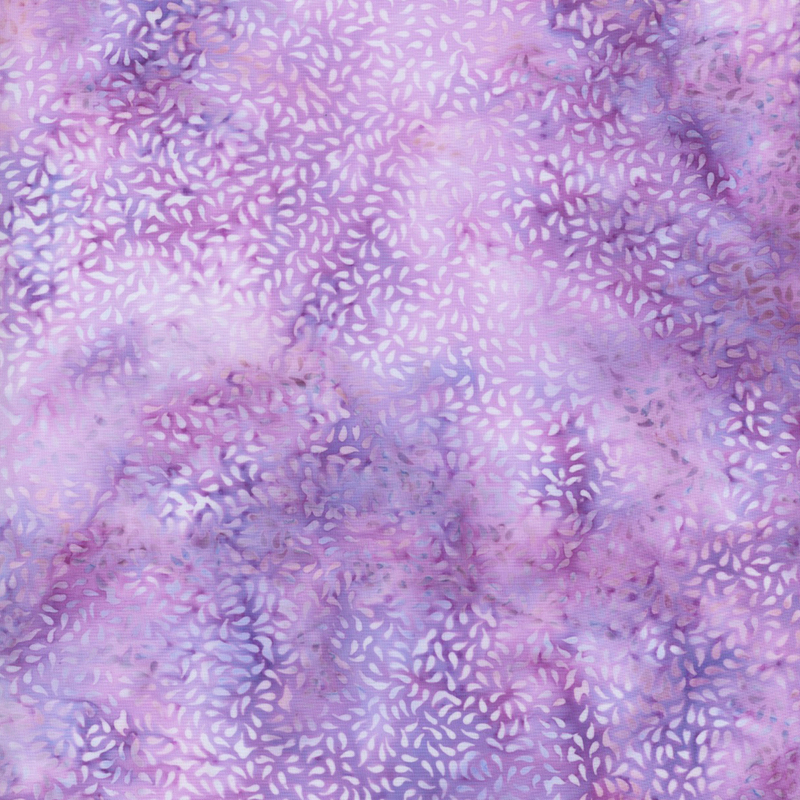 beautiful lilac and purple mottled batik fabric featuring packed together tonal raindrop motifs